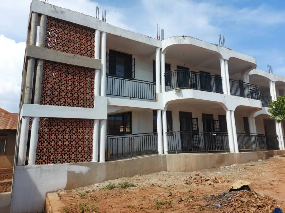 Two-storey reinforced concrete apartment frame with columns, balconies and a breeze-block screen wall